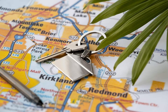 high angle of a key and pen laying on map with cities in the best states to live in circled