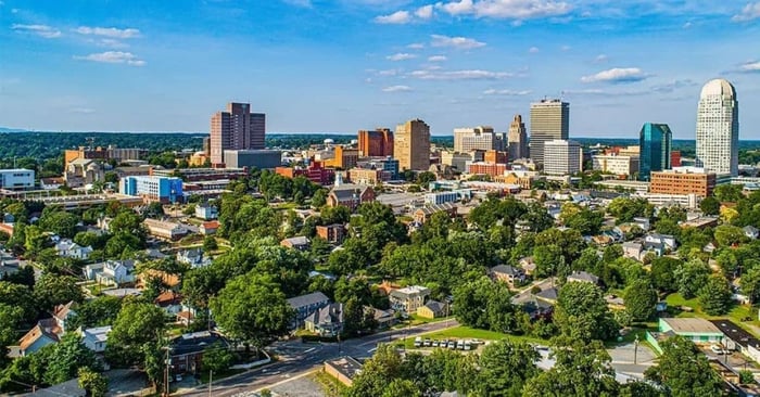 Aerial view of the best places to live in Winston-Salem, NC, featuring city and suburban neighborhoods
