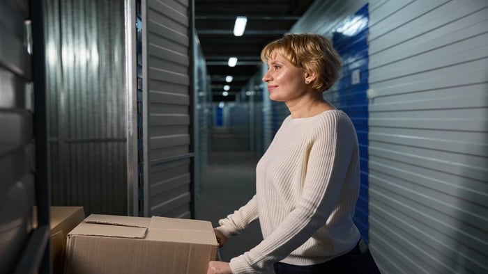 View of self storage airdrie with woman and boxes