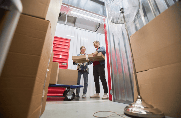 Couple moving items into long-term storage