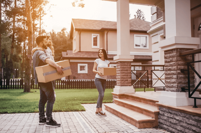 Couple moving items into a summer storage unit