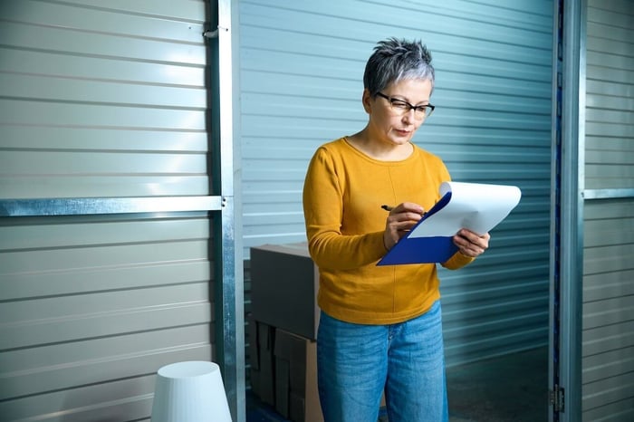 woman inside a unit confirming the correct storage unit size