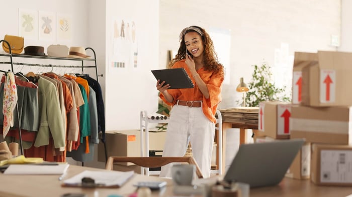Small business inventory management using a tablet beside packed shipping boxes