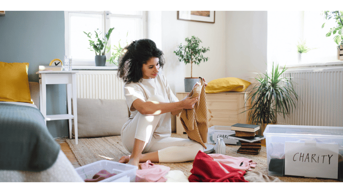 Woman sorting household items while learning how to declutter your home