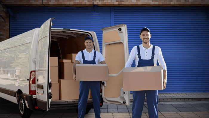 Movers carrying boxes into storage while following a self storage move-in day checklist