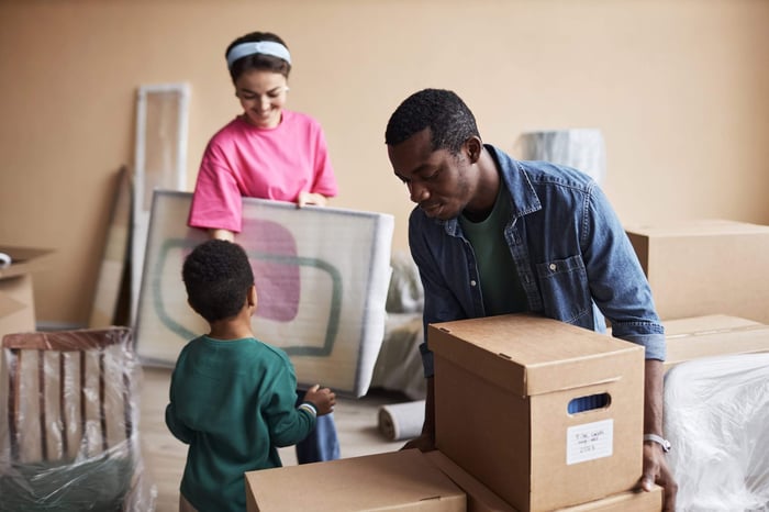 Couple and child packing moving boxes for self storage units Charlotte