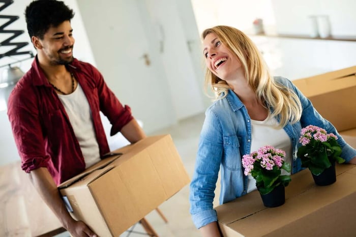 Happy, smiling couple with moving boxes getting ready to go to storage unit rentals in Winston Salem