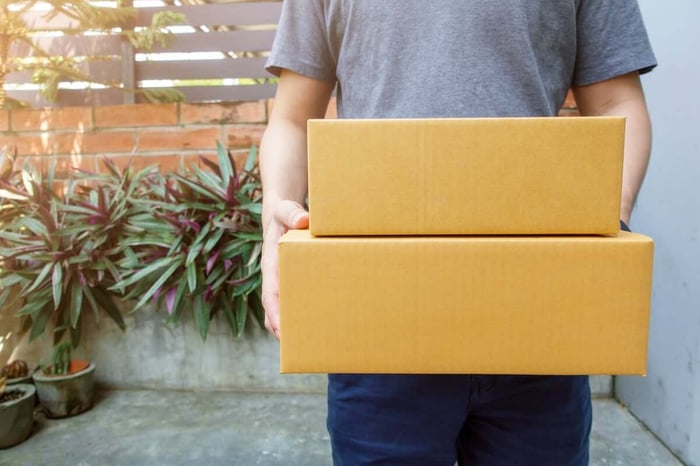 Man holding two boxes for loading into storage units in Clemmons