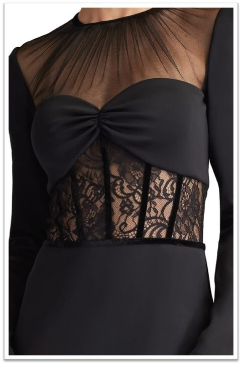 Layering sheer black lace over a red satin mini-dress for eveningwear.
