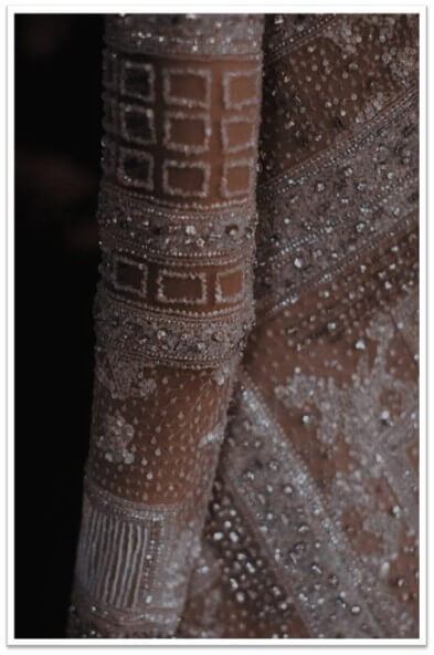 Every detail—from a sequin’s shimmer to the soft gleam of pearls—adds to a garment’s narrative of luxury.
