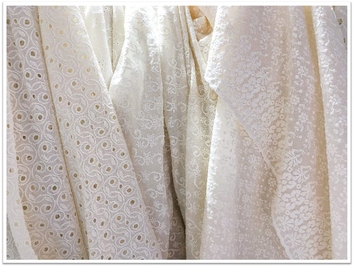 Cotton-based lace like Cotton Embroidery Lace has a stable surface, which makes it easier to sew without shifting under the needle