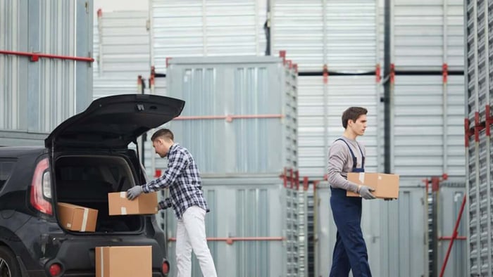 Unloading boxes from the car to put in the storage