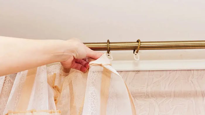 curtain tension rod with a curtain being put up