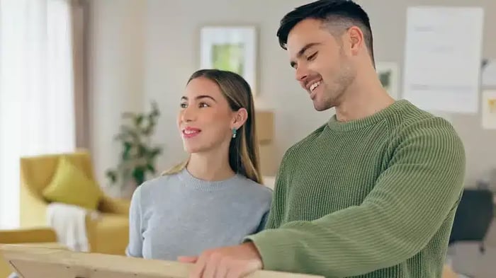 A couple who has recently got married deciding on how to decorate their home.