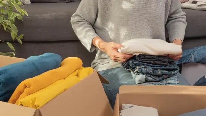 A woman unpacking clothes that she brought back from here storage unit at Mini Mall Storage