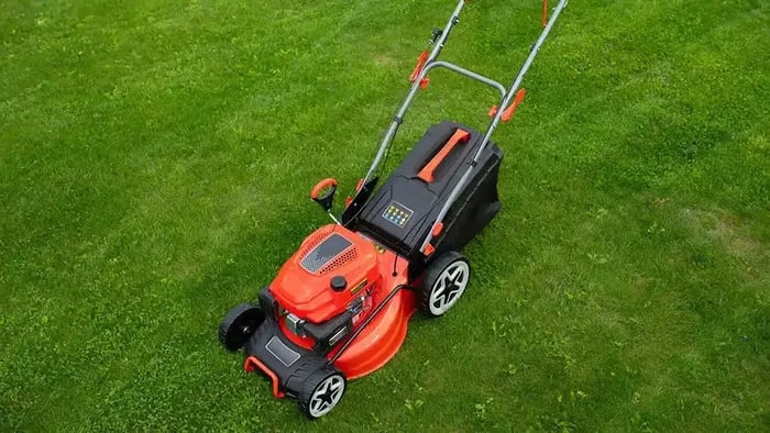 A photo of a lawn mower on grass