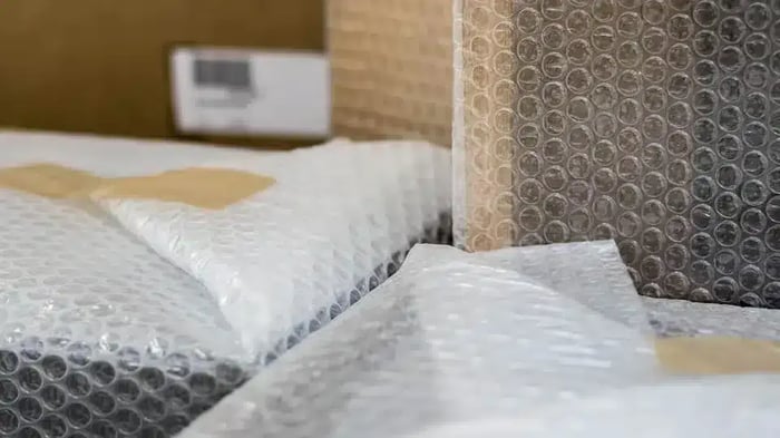 framed photos wrapped in bubble wrap for storage