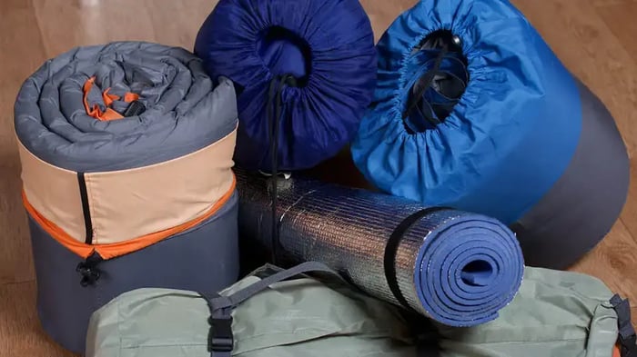 sleeping bags being prepared for storage
