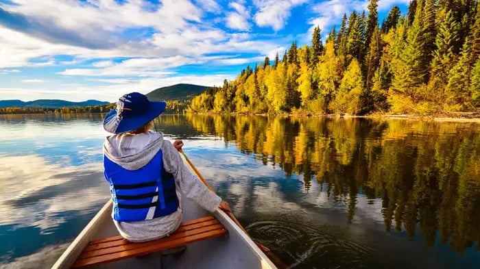 A person kayaking on the Bowron Lake