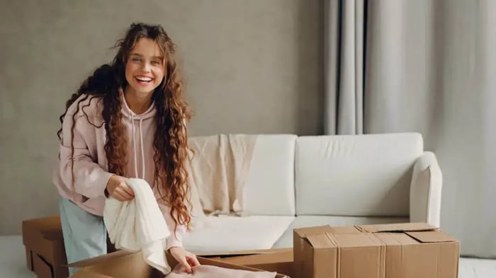 a woman sorting linens for storage