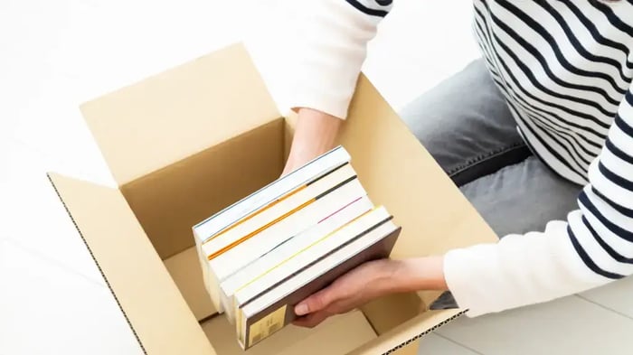 books being stored in a moving box