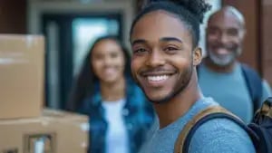 a student and his family with moving boxes