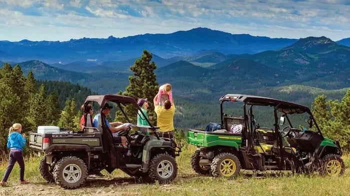 two side-by-sides with mountains in the background