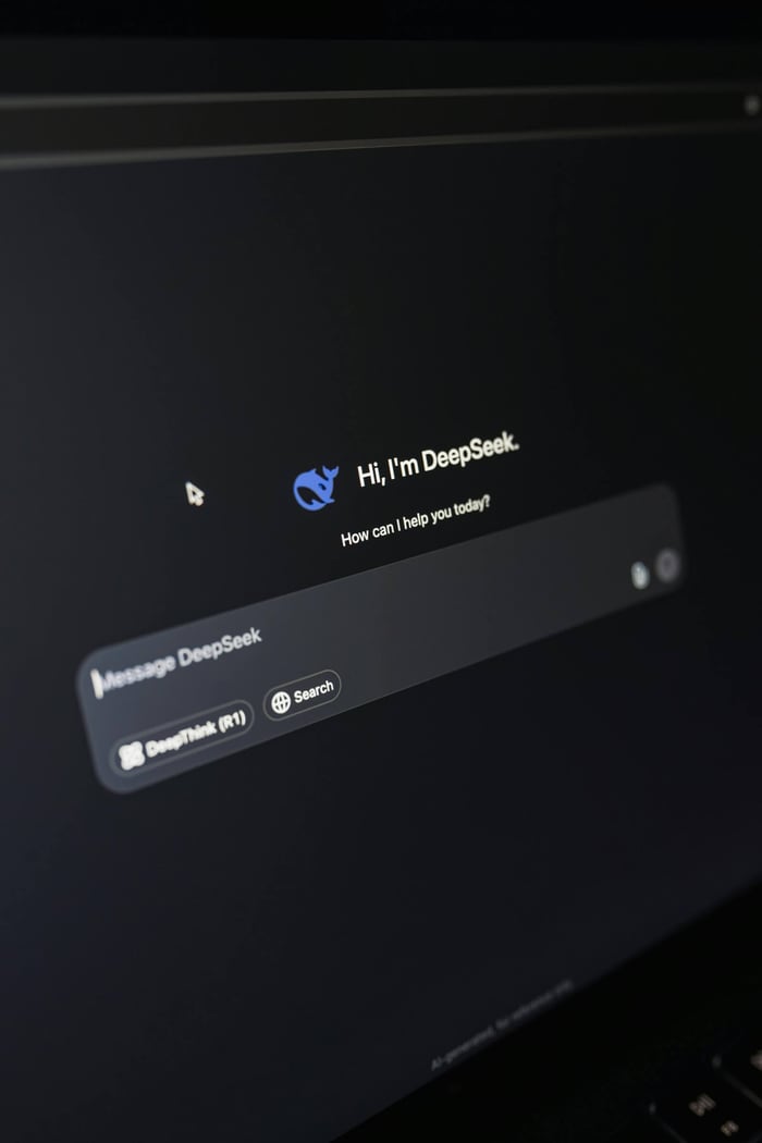 Close-up of a laptop displaying an AI interface with a chatbot prompt in dark mode.