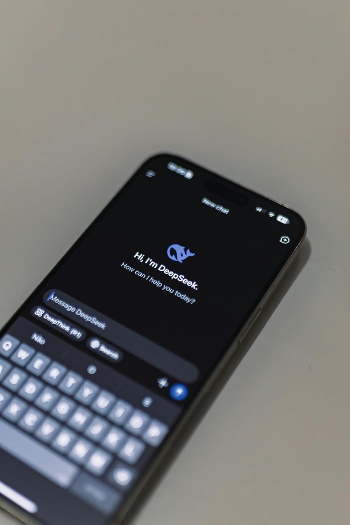 Close-up of smartphone screen showing AI chatbot interface, featuring DeepSeek AI conversation.