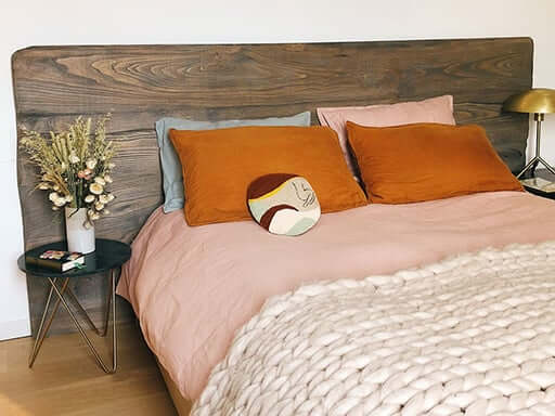 Bohemian bedroom with pink bead and chunky knit blanket