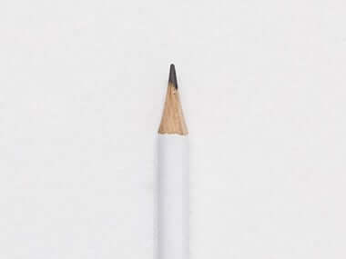 Minimalist sharpened white pencil isolated on white background