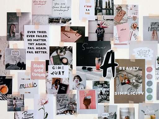 Inspirational posters taped to a white wall