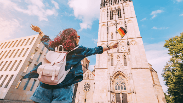 College student traveling abroad with a backpack near a university campus