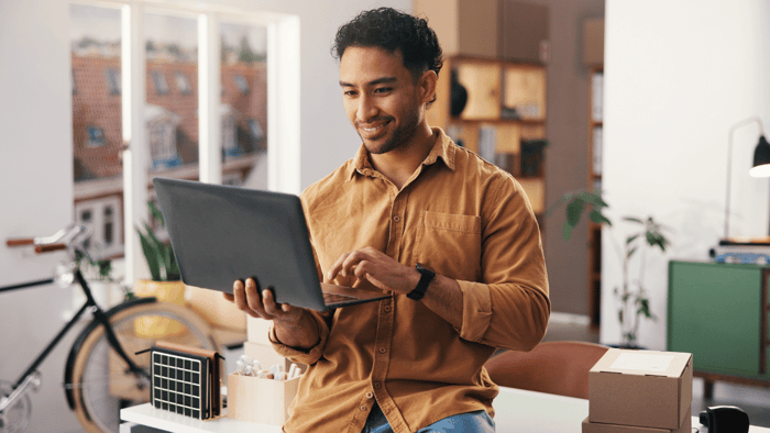 Man reviewing storage unit pricing and expenses at a desk