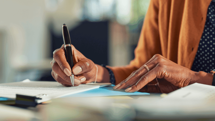 Person reviewing and signing storage rental paperwork before move-in day
