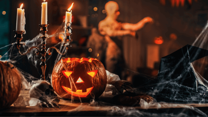 Ceramic pumpkins, candles, and Halloween decorations arranged on a table before packing