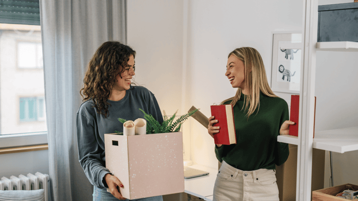 College roommates packing boxes before moving out for summer break