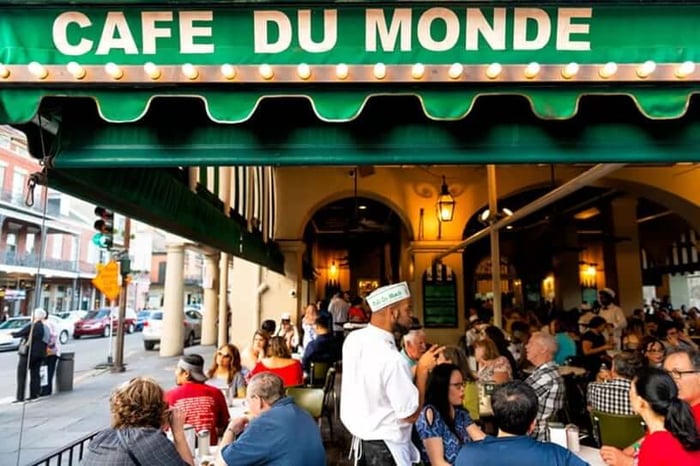 An outdoor restaurant filled with customers.