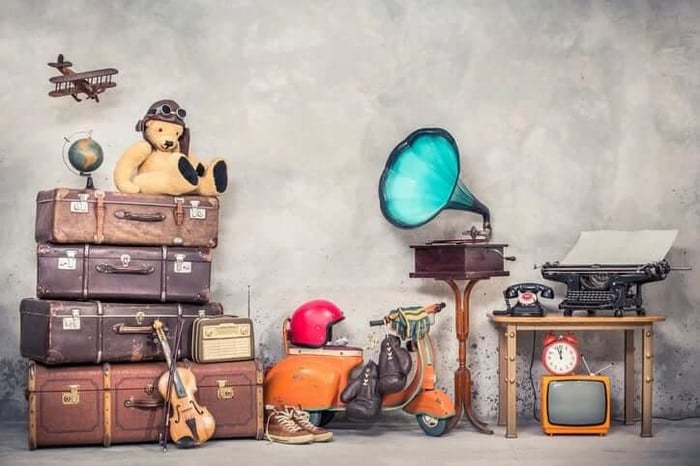 Antique items including a phonograph, typewriter and old luggage.