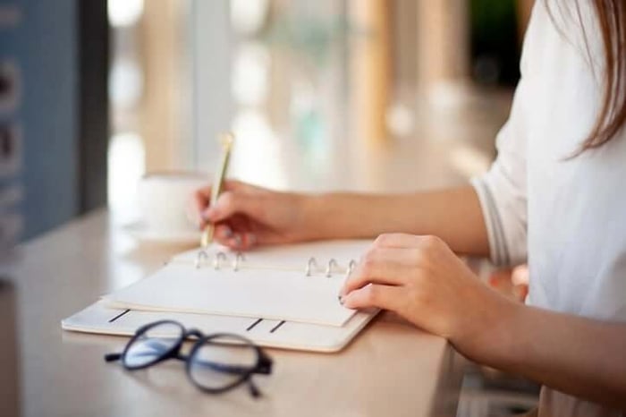 person writing in a planner