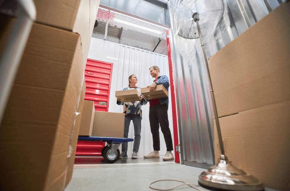 Couple moving items into long-term storage