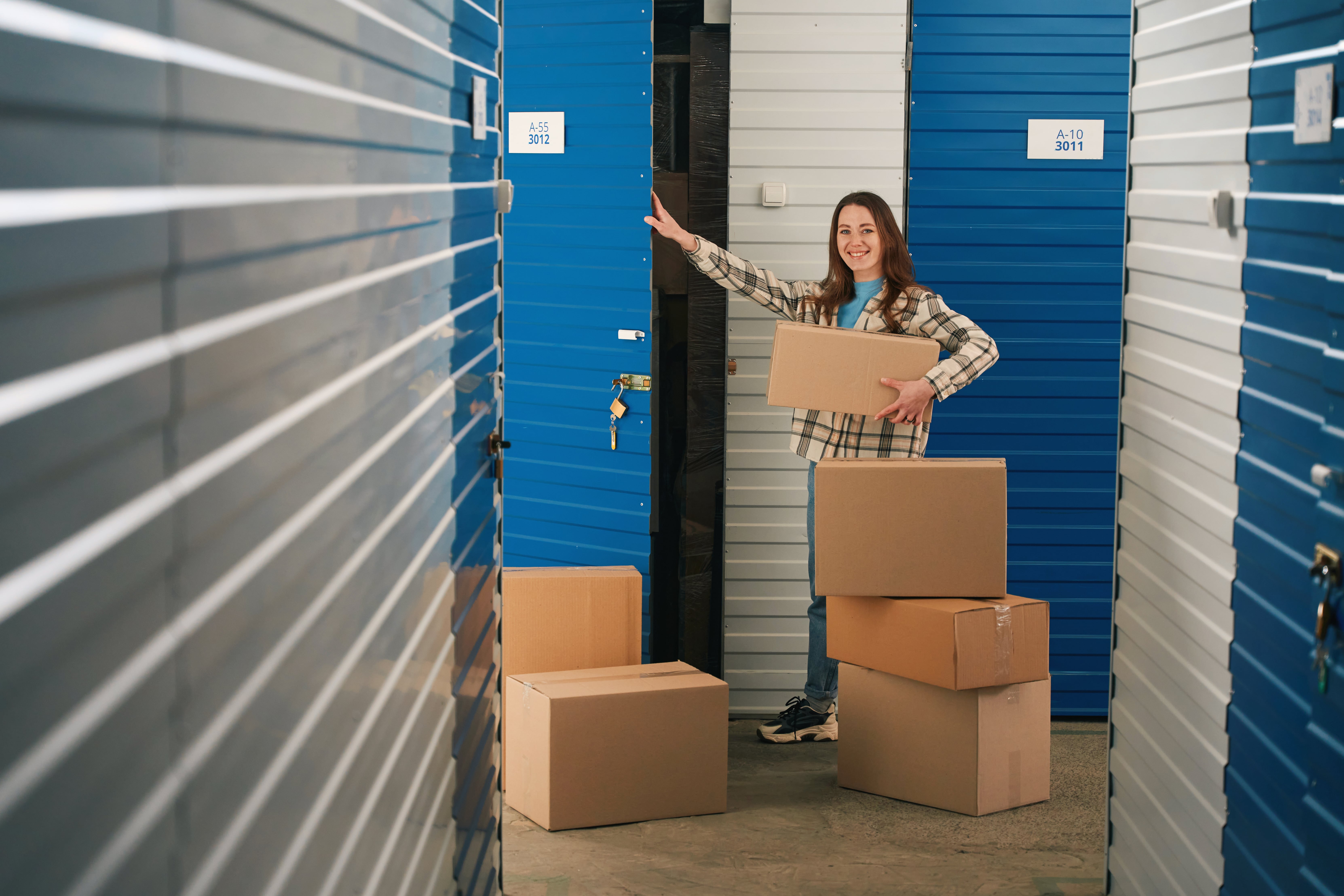How to pack a self storage unit with labeled boxes organized inside an indoor storage facility