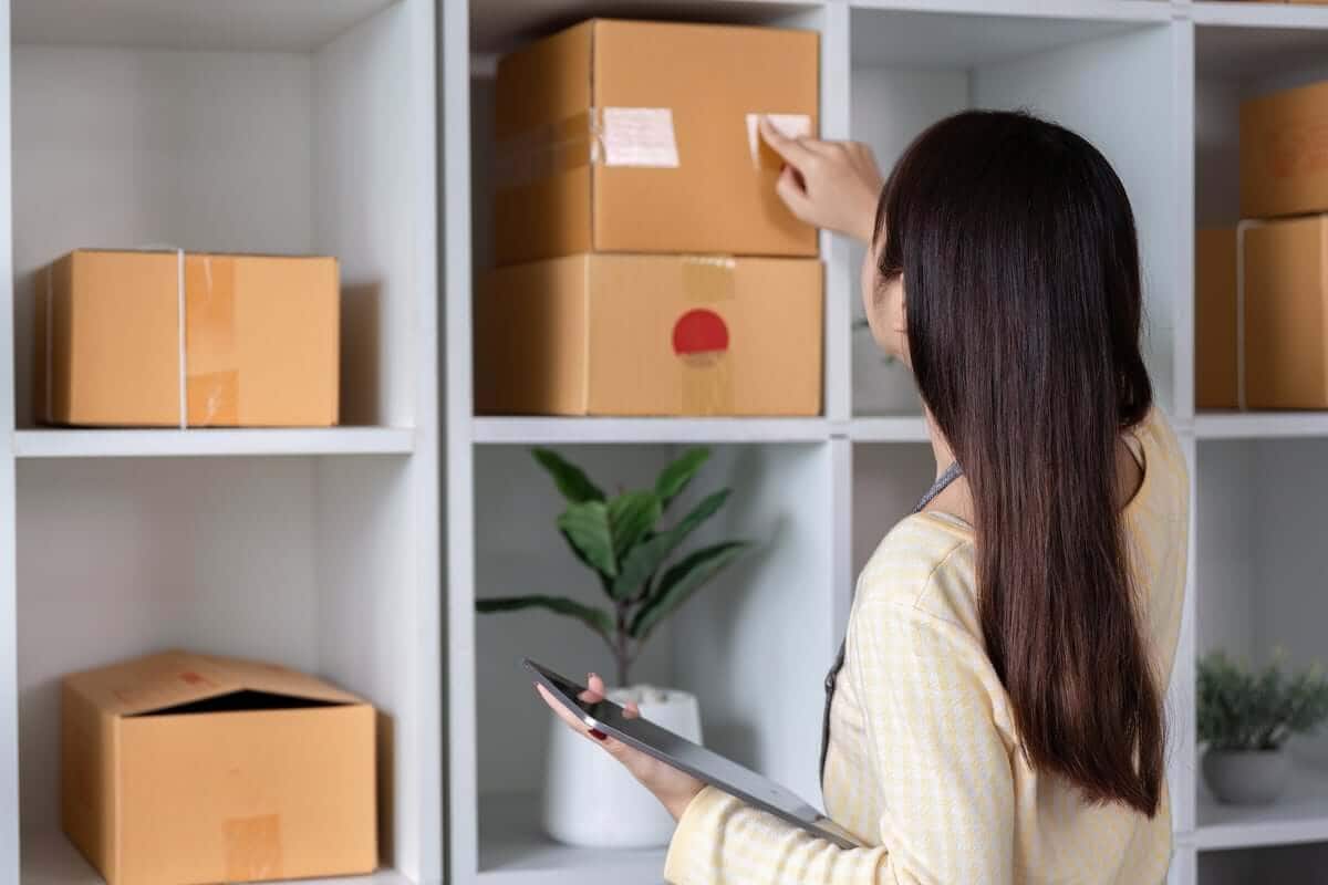 Woman labels boxes getting ready for storage units in Greensboro