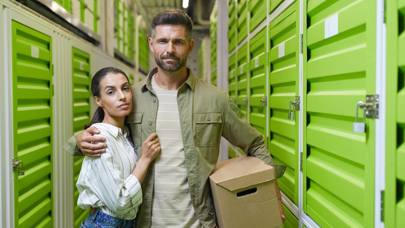 Climate-controlled storage in Beaumont with customers carrying boxes inside an indoor storage facility