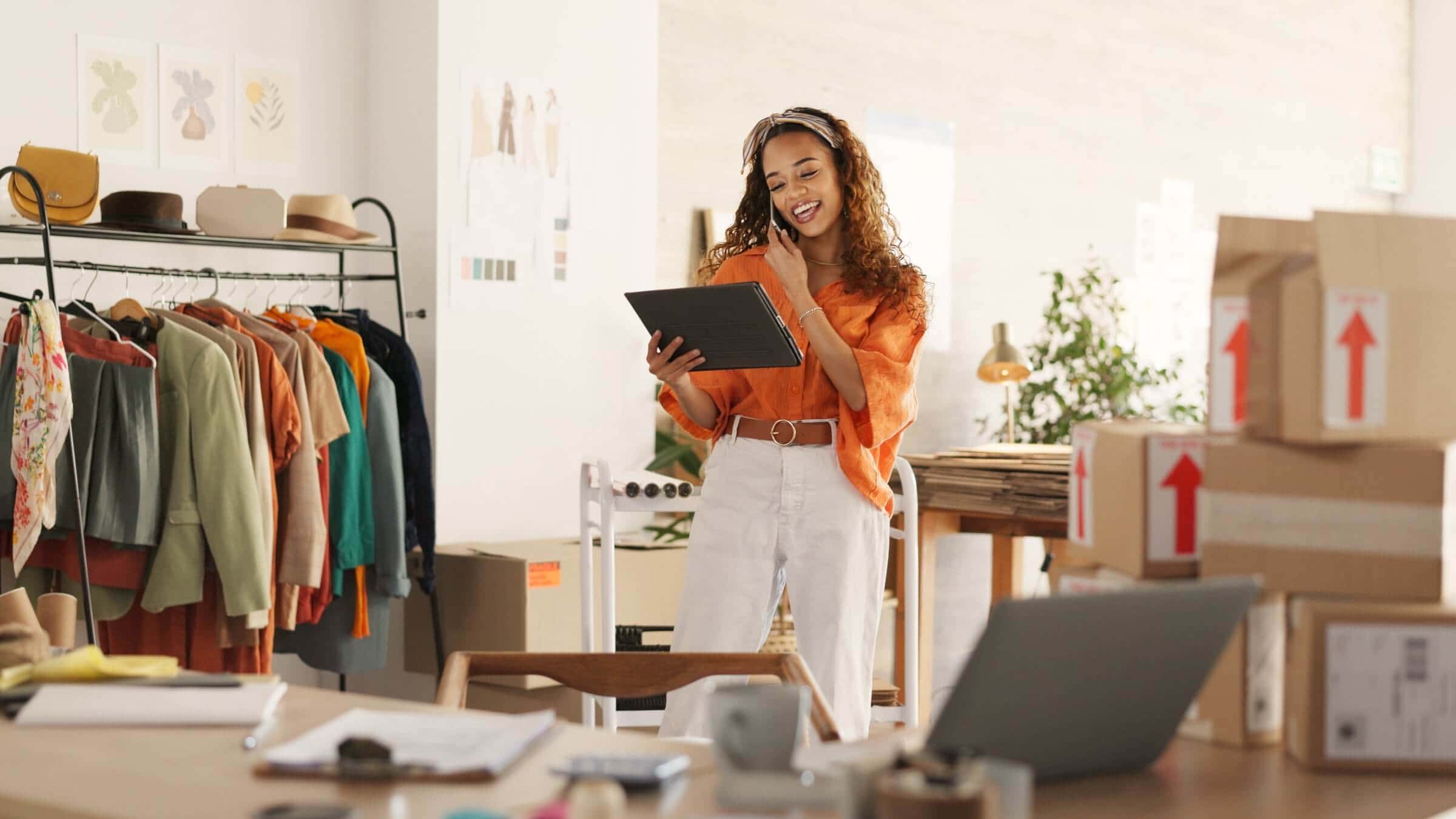 Small business inventory management using a tablet beside packed shipping boxes